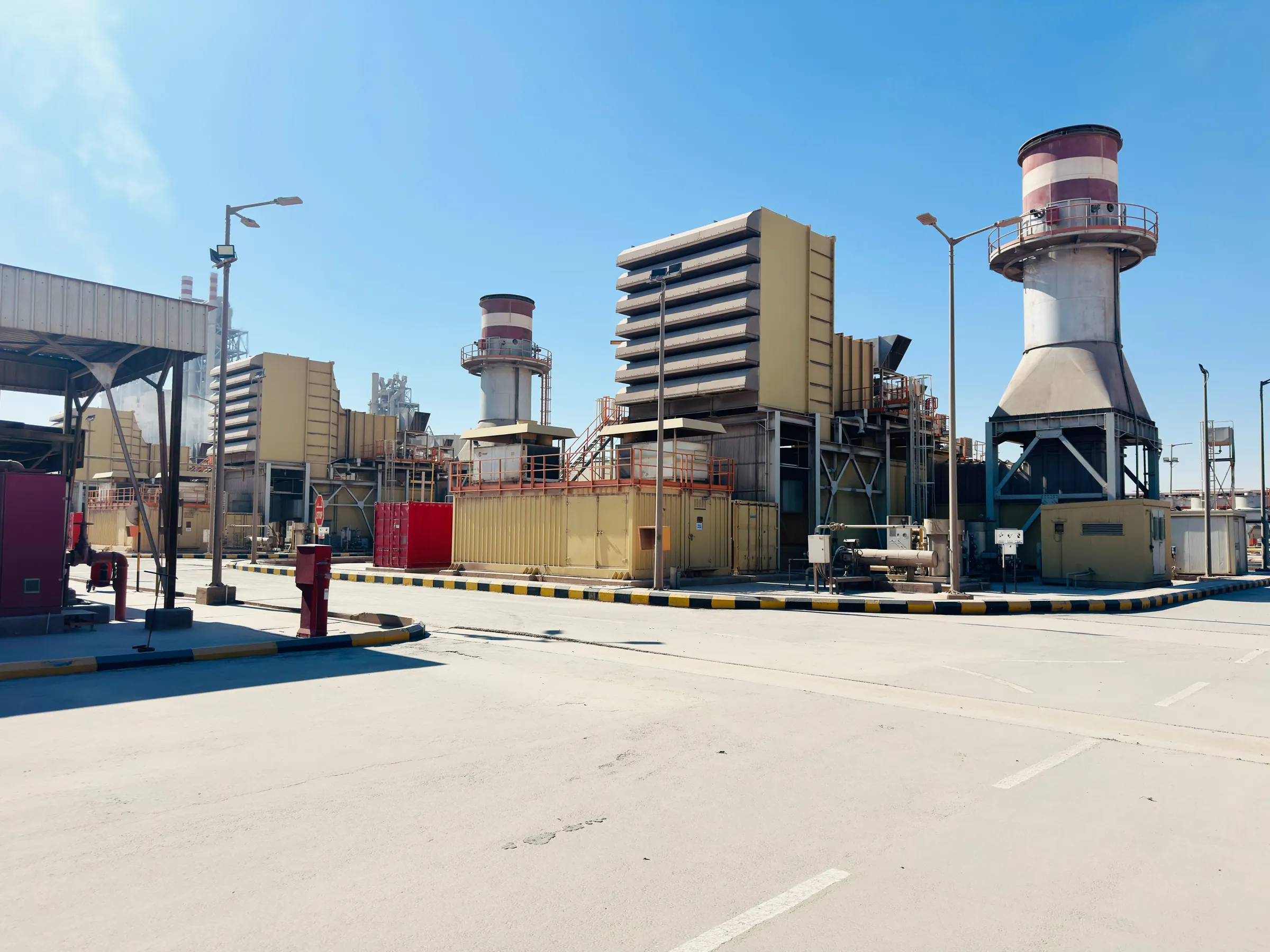 Gas turbine power plant under a clear blue sky